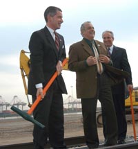 Governor McGreevey lays the first piece of track in the initial phase of a new $80 million ship-to-rail facility at the Newark/Elizabeth Port Authority Marine Terminal. The new rail facility is part of $4.4 billion in public and private sector investments in the port. With him are Vince Alisi, Secretary Treasurer of the International Longshoremen's Association, Local 1238 and Commissioner Jack Lettiere.